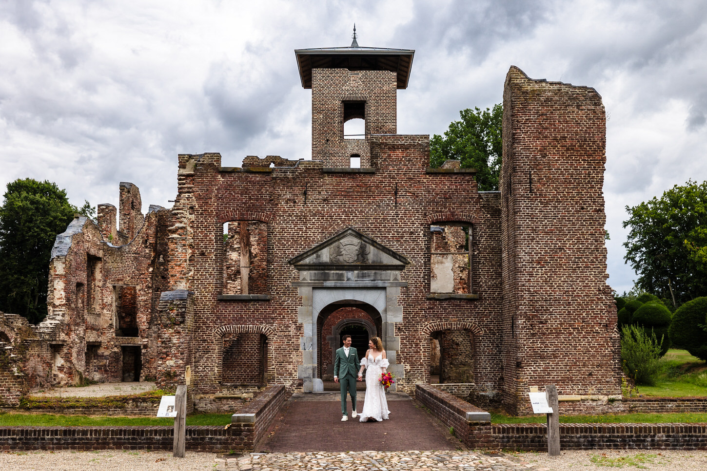 bruidspaar wandelt met kasteel bleijenbeek op de achtergrond