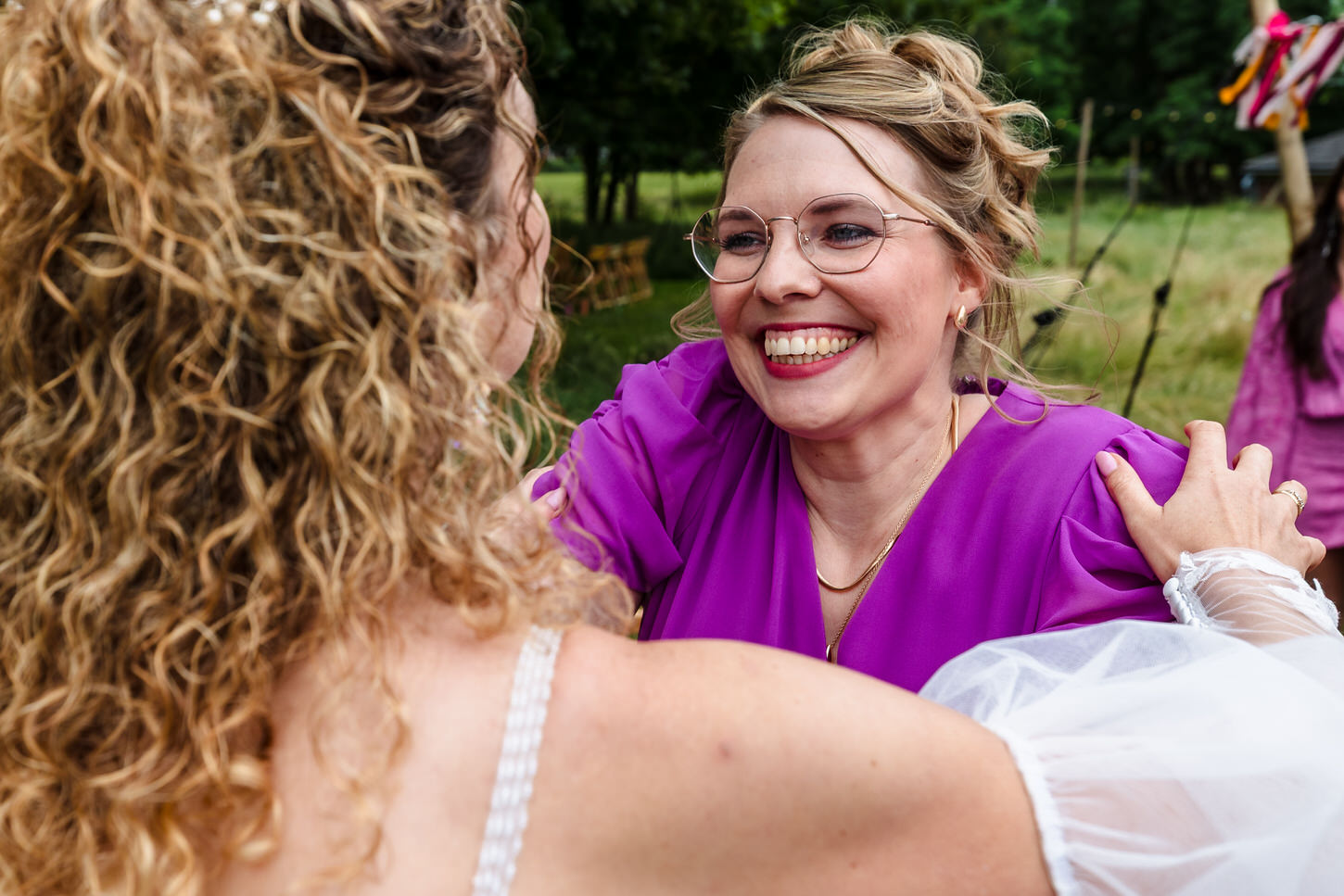 bruid wordt gefeliciteerd door zus