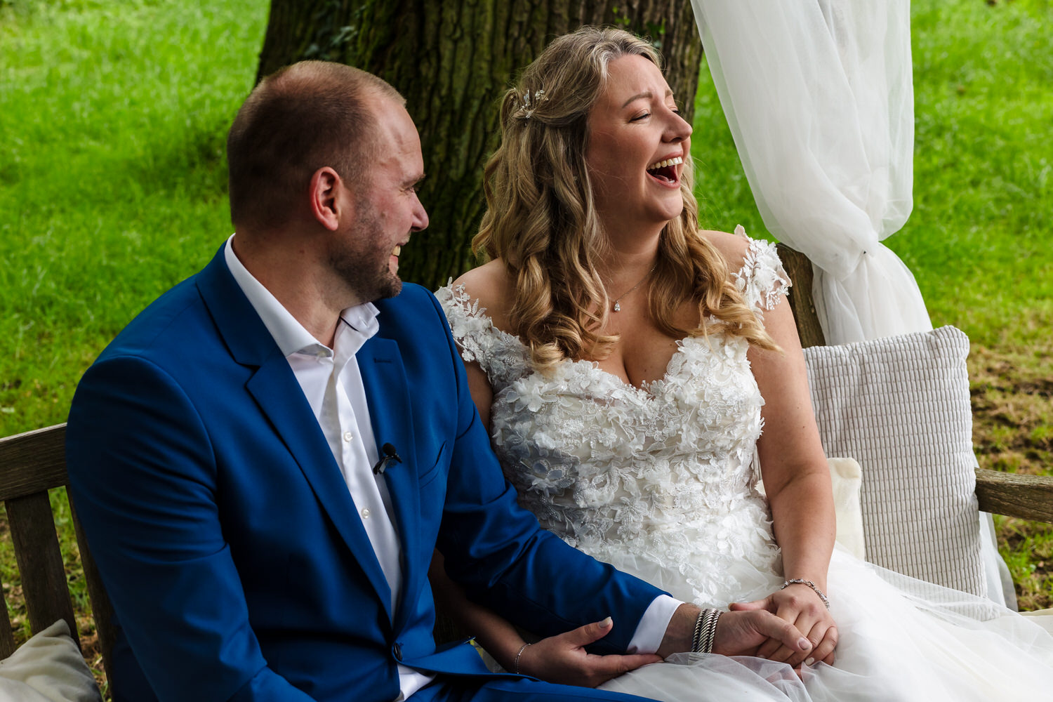 lachend bruidspaar tijdens de ceremonie bij landgoed brakkesteyn